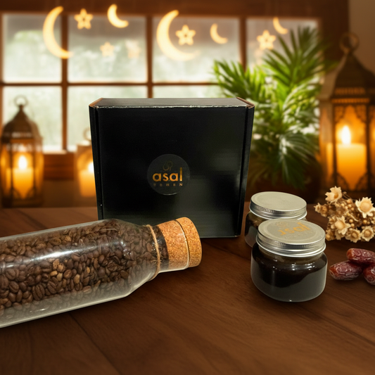 Asal Yemen Ramadan Gift Set with black box, coffee beans bottle, and branded jars in a warm golden Ramadan setting